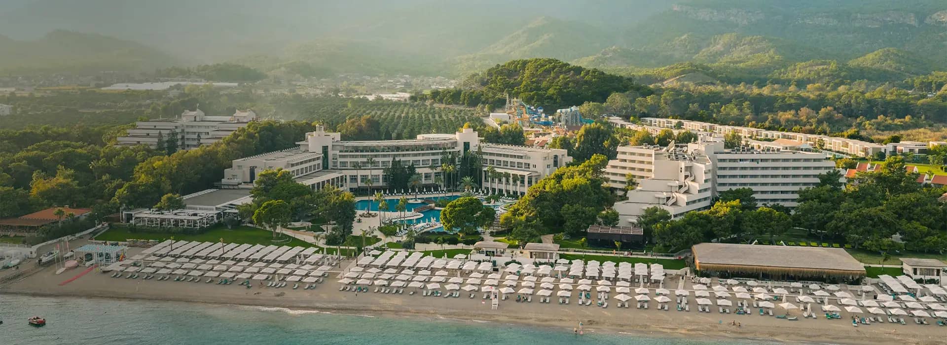 <div style="padding-left: 70px;"><img style="width: 100px; height: auto; margin: 25px 0;" src="https://b2ccdn.coraltravel.lt/content/Main Page Hotels Banners Destinations_Turkyie LT.svg"></div>
<div style="padding-left: 70px; margin-bottom: 20px;"><img style="width: 200px; height: auto;" src="https://b2ccdn.coraltravel.lt/content/logos/hotel-logos/rixos-logo-white-200-55.webp" loading="lazy"></div>
<div style="font-size: 28px; font-weight: 600; padding-left: 70px;">RIXOS PREMIUM TEKIROVA</div>